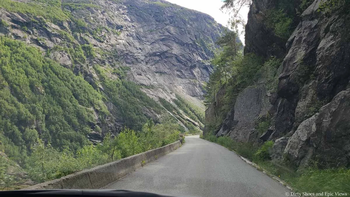 A narrow road winds along a rocky cliff on the way to Trolltunga in Norway