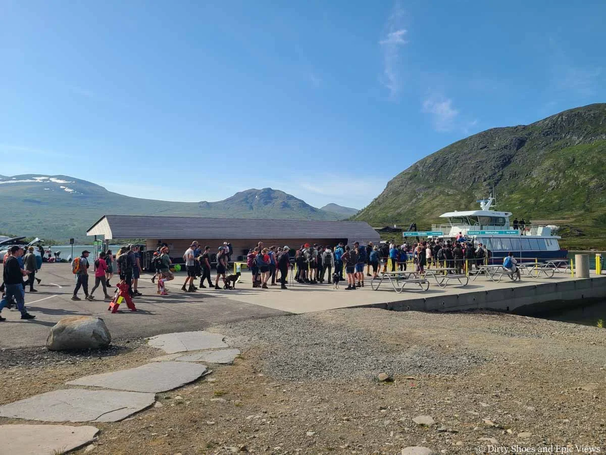 A line of hikers wait to get on the Besseggen Ridge ferry