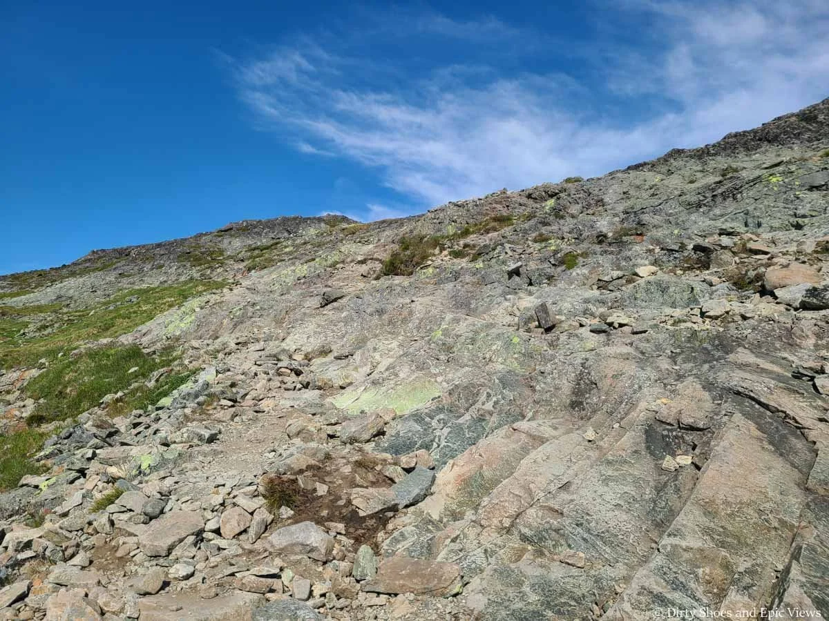 A rocky path ascends a hill on the Besseggen Ridge trail