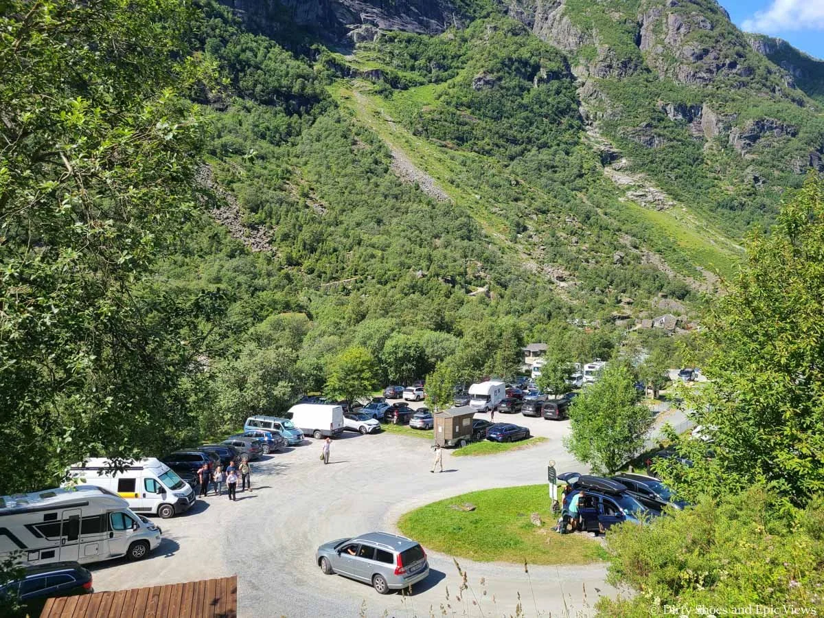 A large parking lot is full of cars at the Briksdal Glacier trailhead