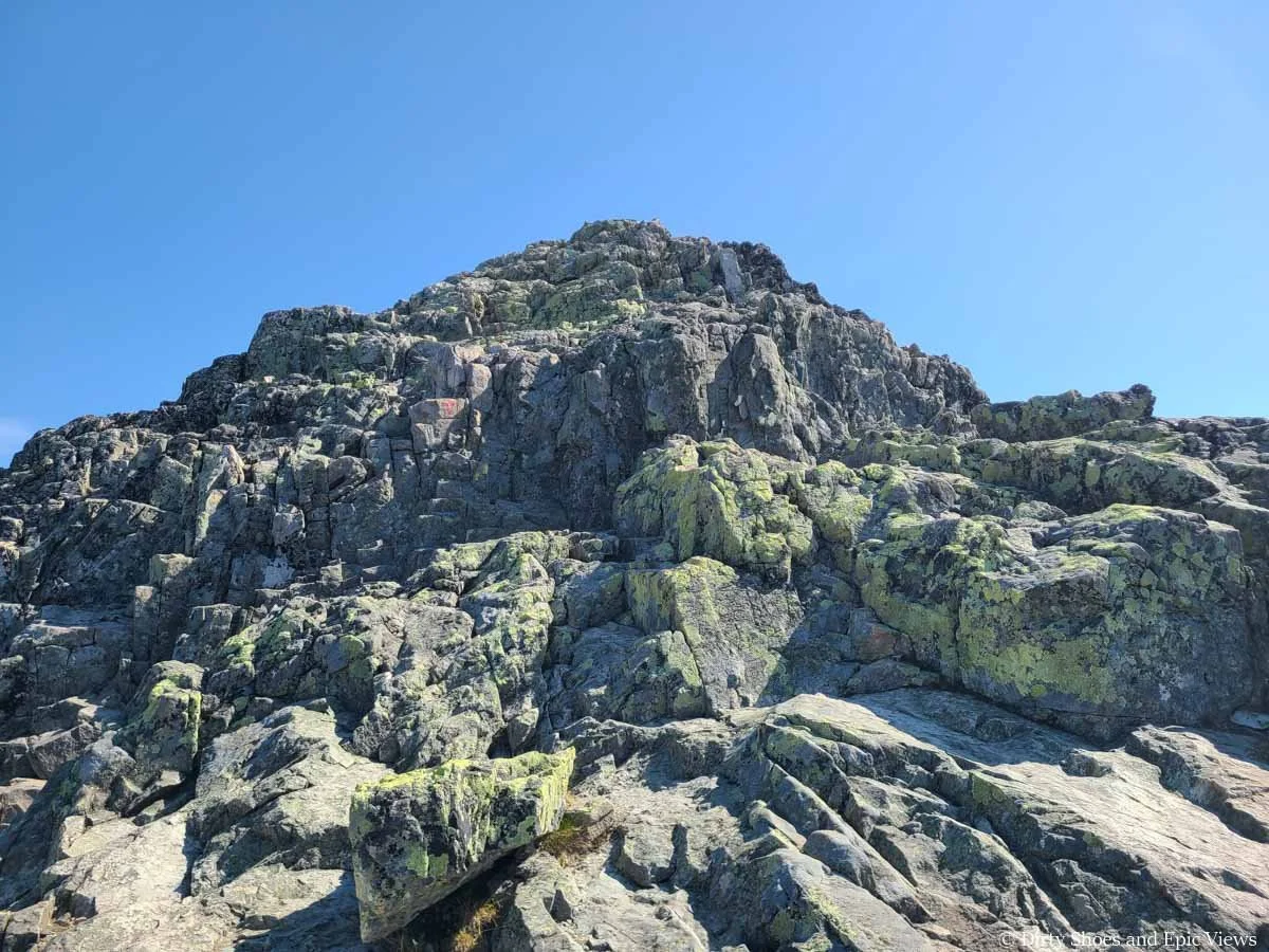 Trail markers lead the way up a rocky spine on the Besseggen Ridge trail