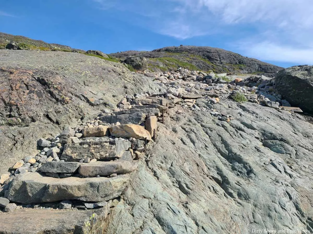 Stone steps ascend a granite rock along the Besseggen Ridge trail in Norway