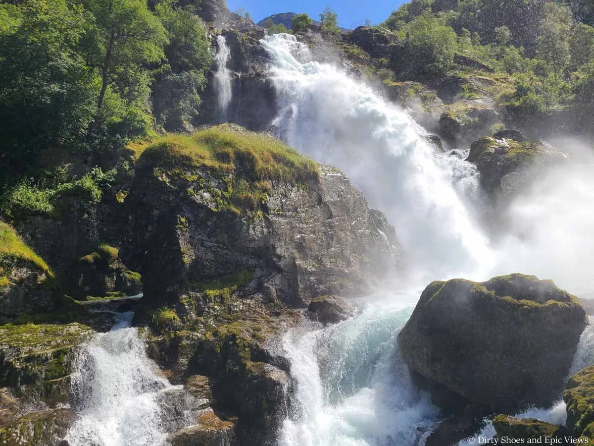 A powerful waterfall along the Briksdal Glacier trail in Norway
