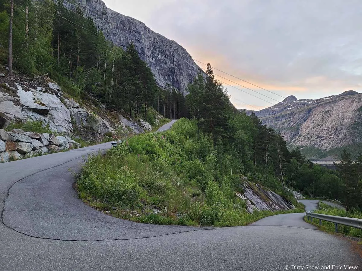 A paved road switchbacks up the mountainside on the way to the Trolltunga trailhead
