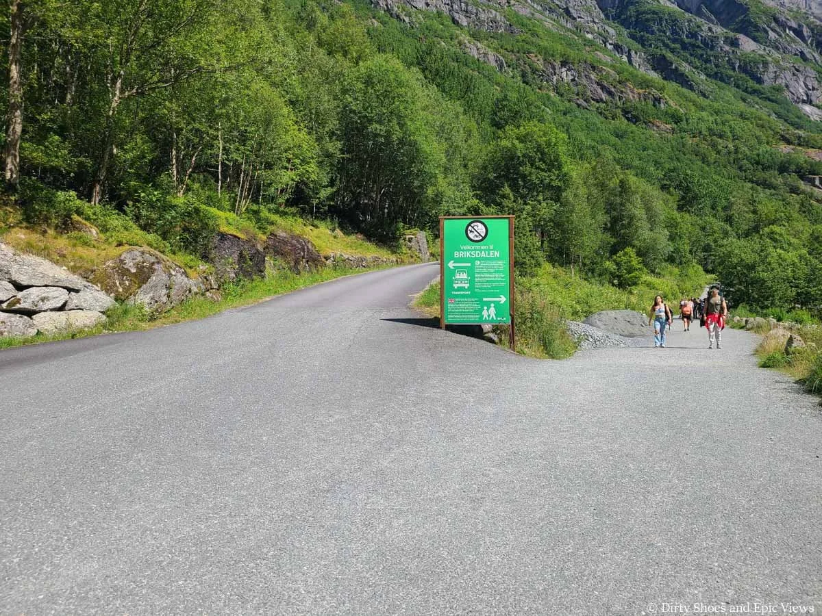 A crowded paved path forks on the way to the Briksdal Glacier in Norway