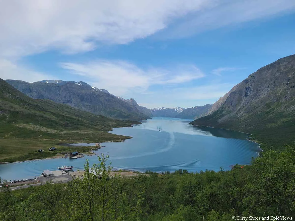 A view over a large blue lake surrounded by rocky cliffs as seen from the Besseggen Ridge hike in Norway