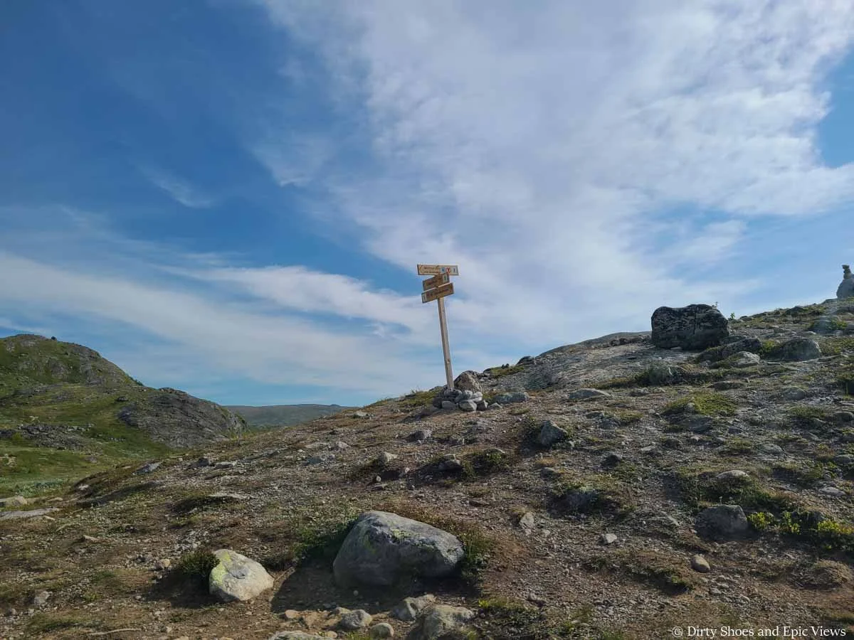 A trail sign marks a junction along the Besseggen Ridge hike in Norway