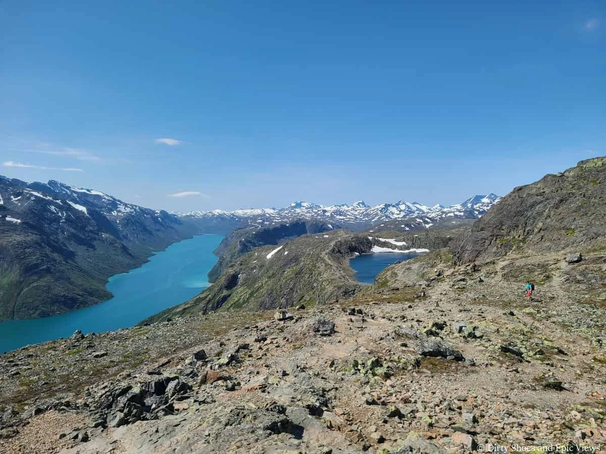 A herd path leads down a rocky slope towards two lakes on the Besseggen Ridge hike