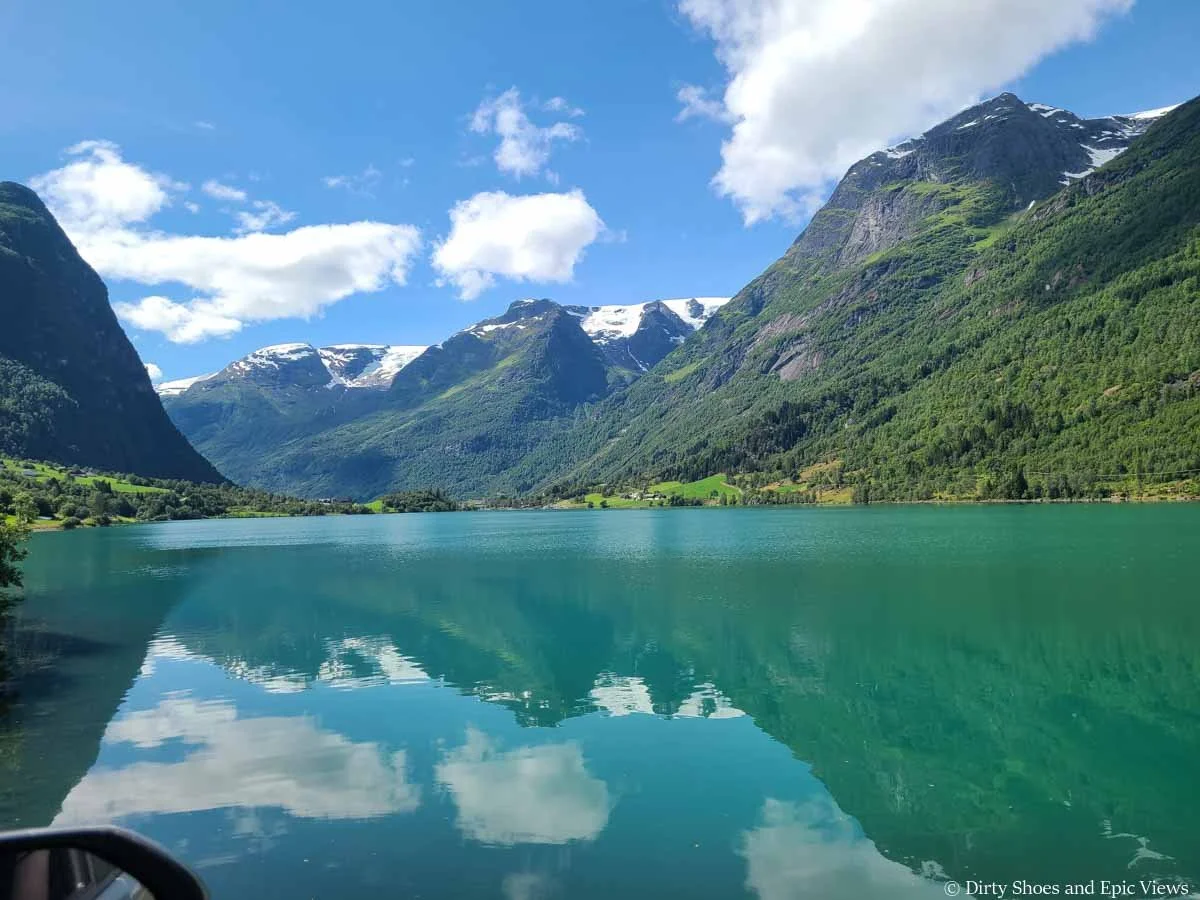 Mountains sit over a bright blue lake on the drive to the Briksdal Glacier in Norway