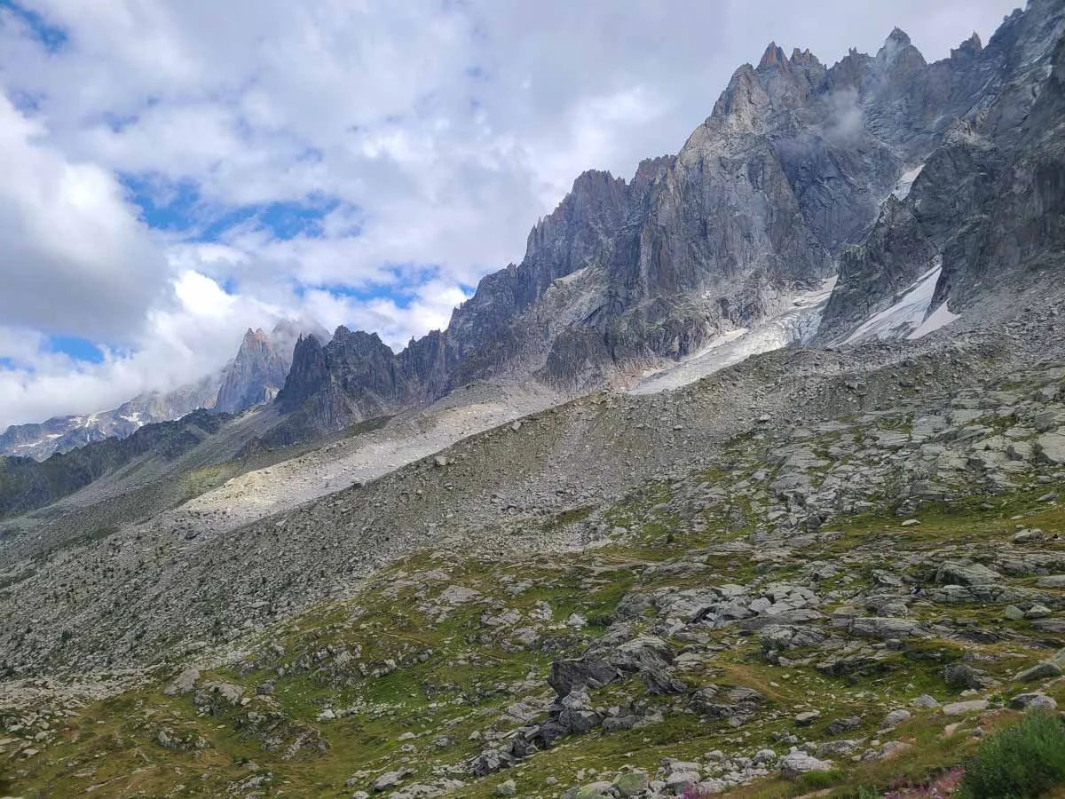 Jagged mountain peaks tower above rocky meadows at the start of the Grand Balcon Nord trail in Chamonix