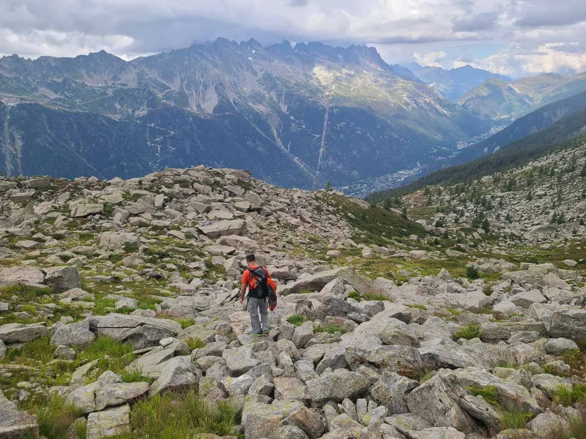 A hiker navigates a boulder field near Lac Bleu in Chamonix