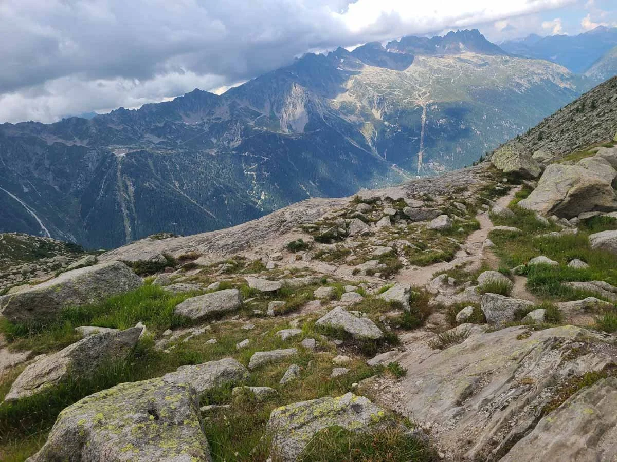 Herd paths lead from Lac Bleu in Chamonix with mountains in the distance