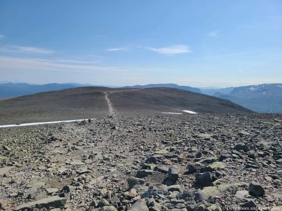 A herd path crosses a rocky landscape on a mountain plateau along Besseggen Ridge in Norway