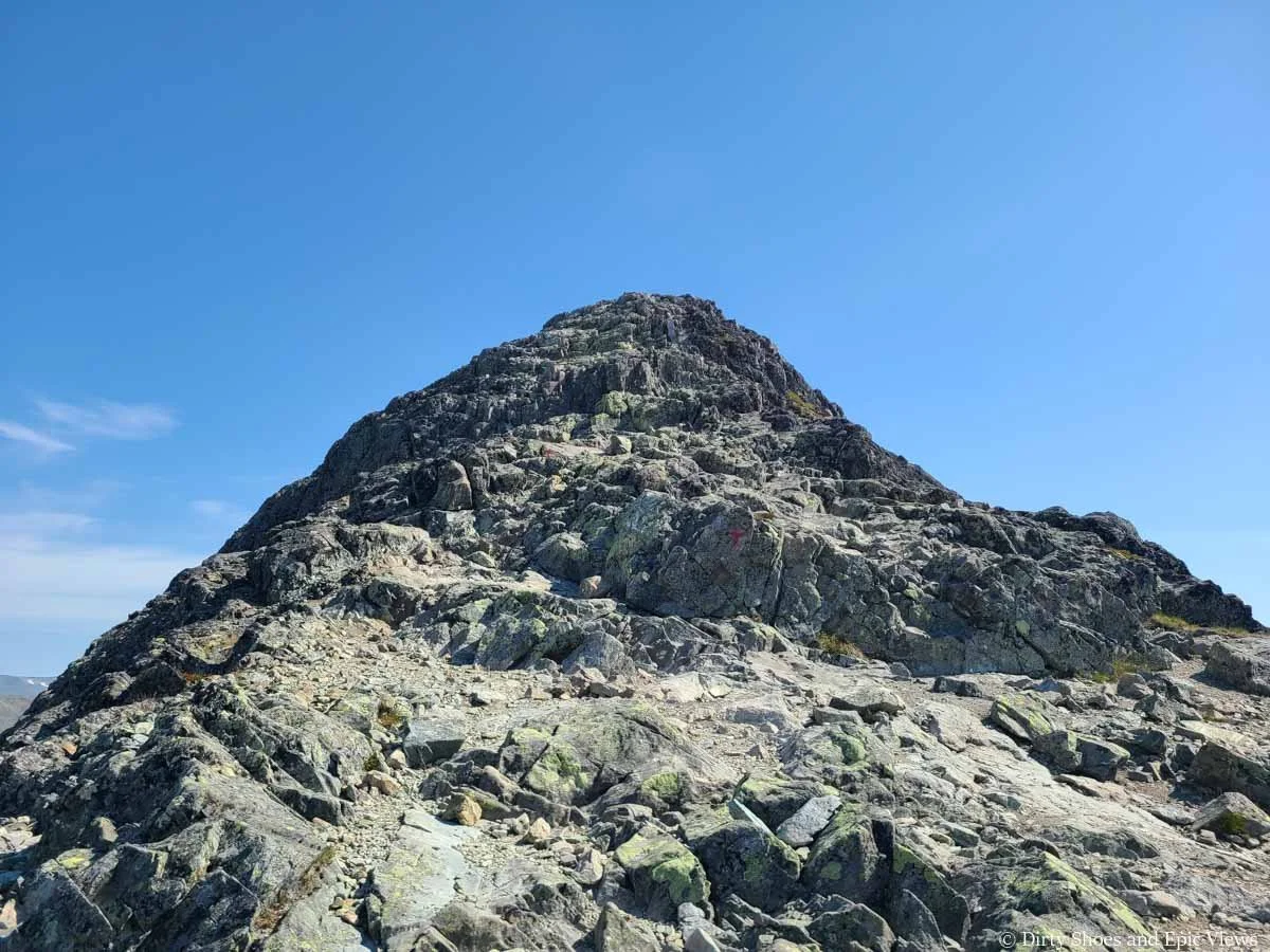 A herd path navigates up a narrow rock ridge on the Besseggen Ridge trail in Norway