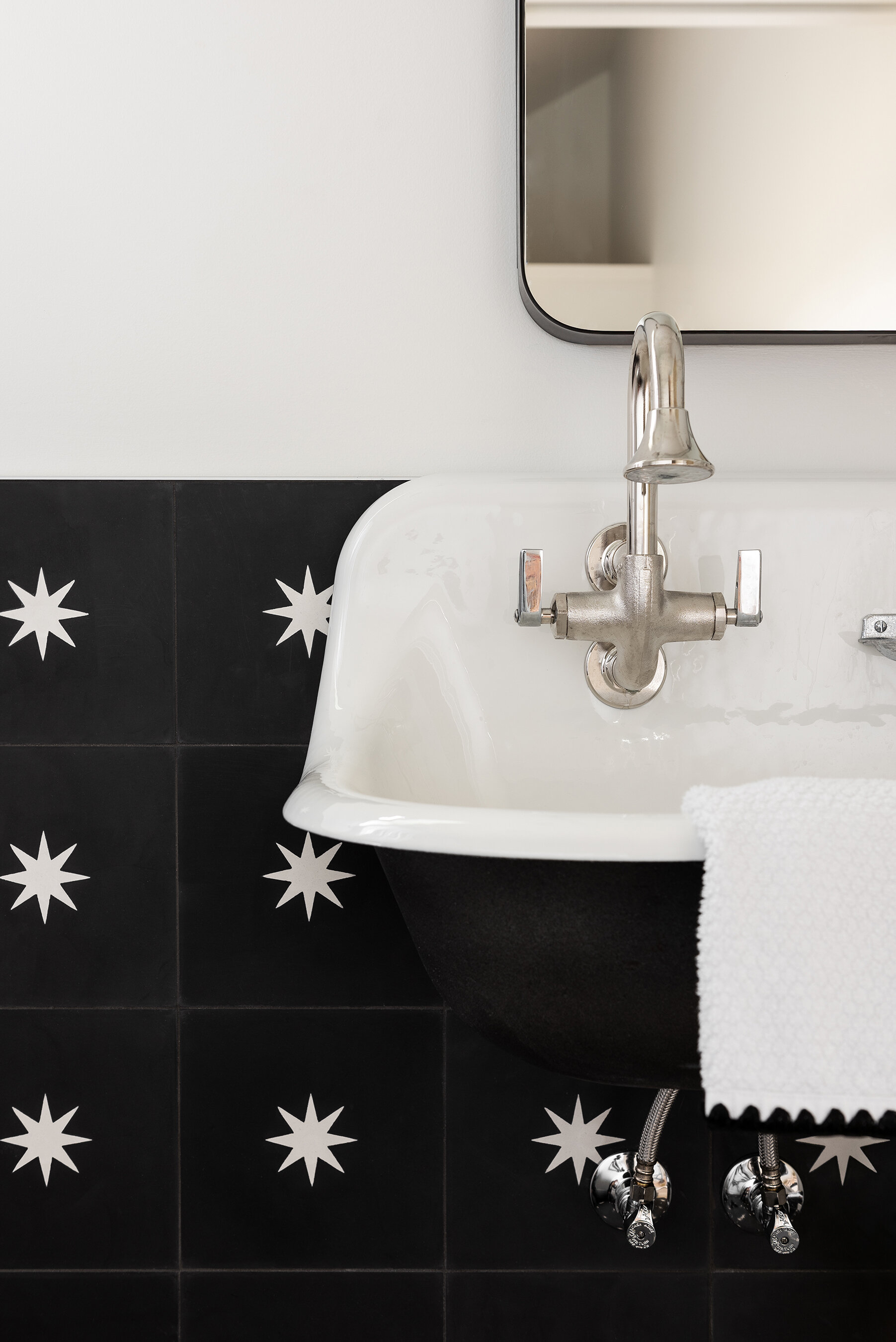 Black and white tiled sink area