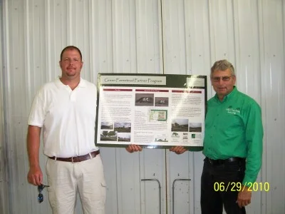 The picture above is of Ryan Reed (left) of Ottumwa, Iowa, and his tree planting around his hog buildings that we helped design and supplied the trees for. With their planting of trees and other things Ryan and Lana have done they were awarded the 2012 Pork Industry Environmental Stewards award. Click on the right link to see pictures, article and video on what they have done to deserve this honor of a pork producer. Aerial picture shown right.