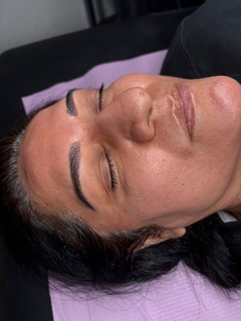 Permanent makeup nano brows on client showing natural, soft hair strokes and defined brow shape.
