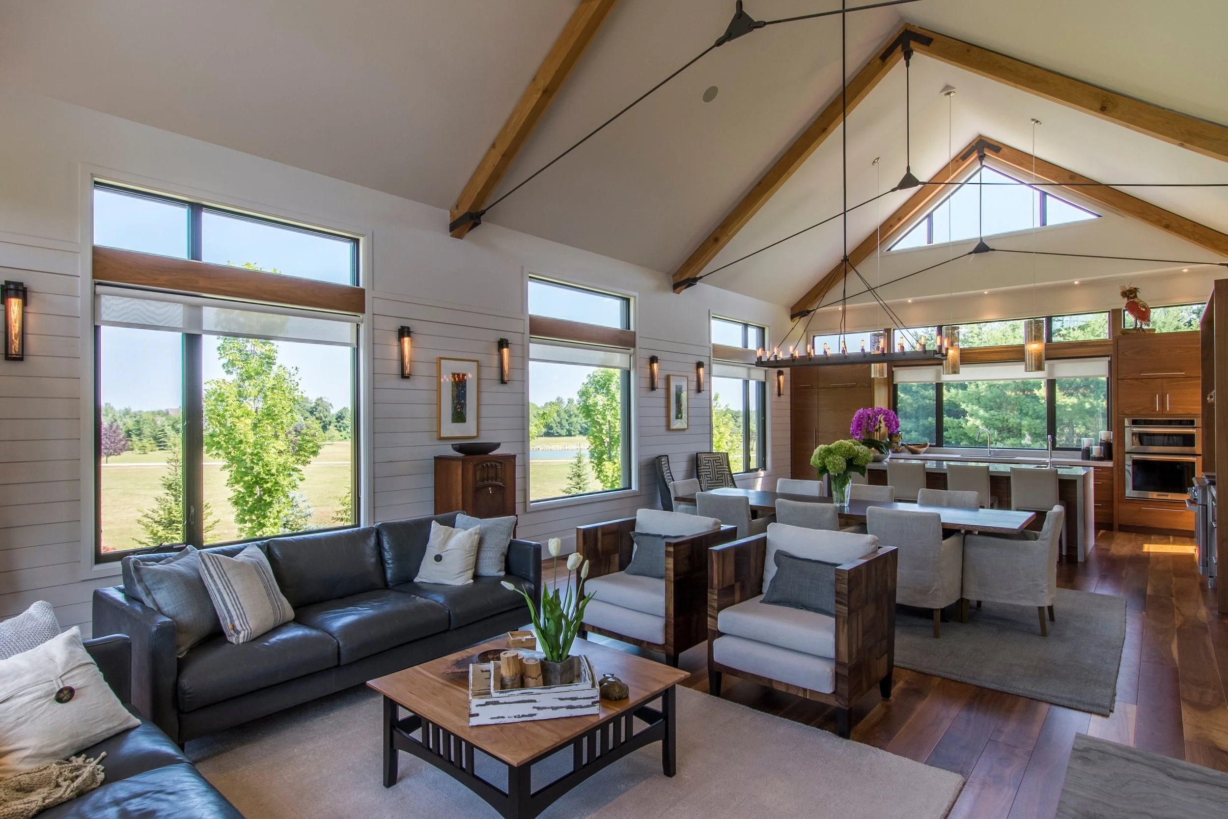 Interior with floor-to-ceiling windows opening to a forested view