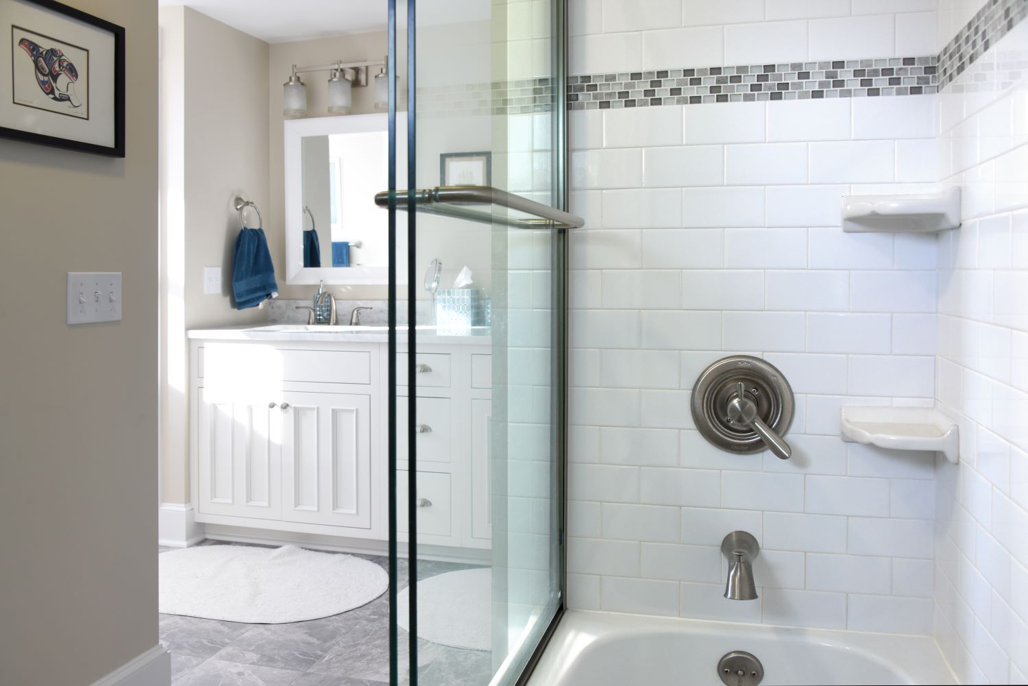 bathtub and shower with subway tile and glass door