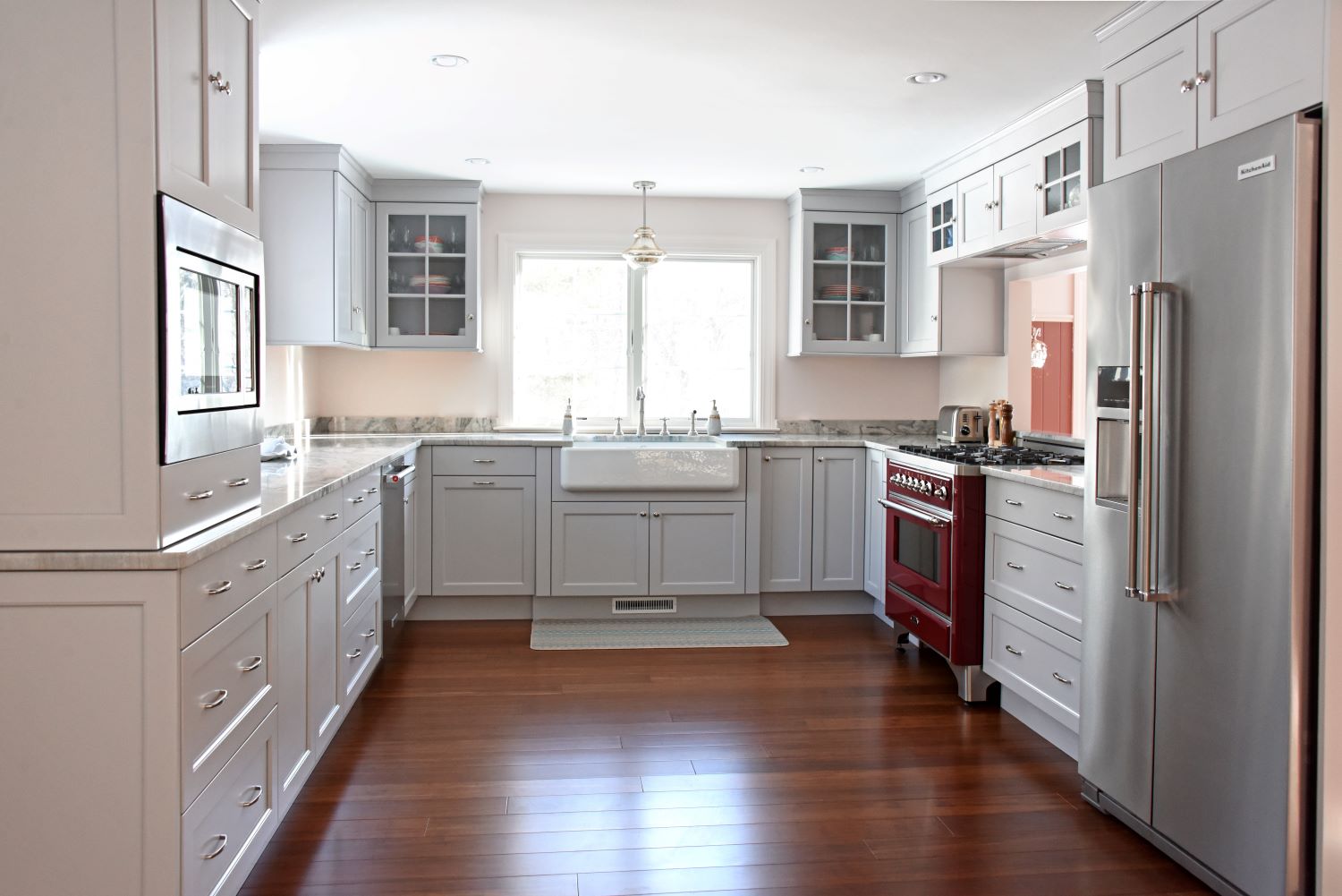 kitchen renovation with red stove and farmhouse sink