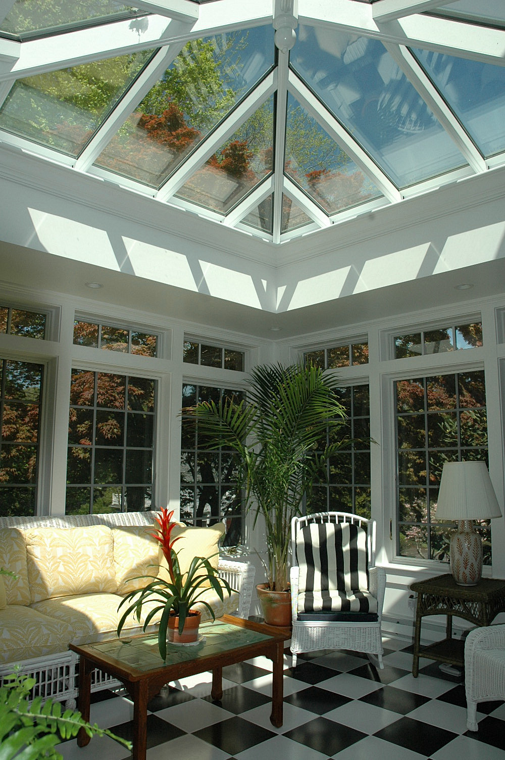 sunny conservatory with glass roof and tile floor