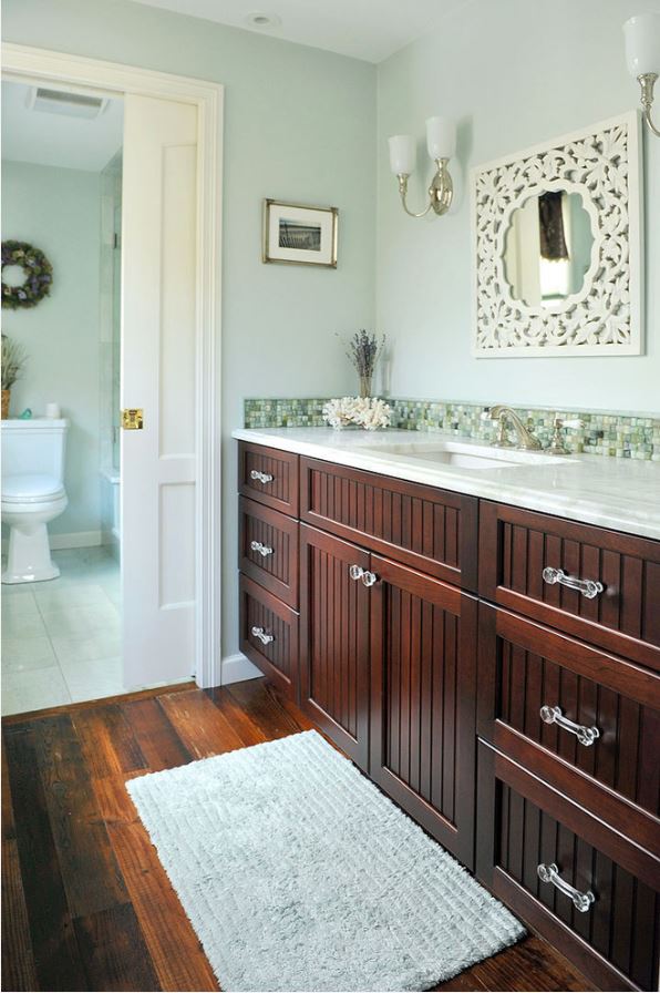 bright bathroom renovation with dark wood cabinets