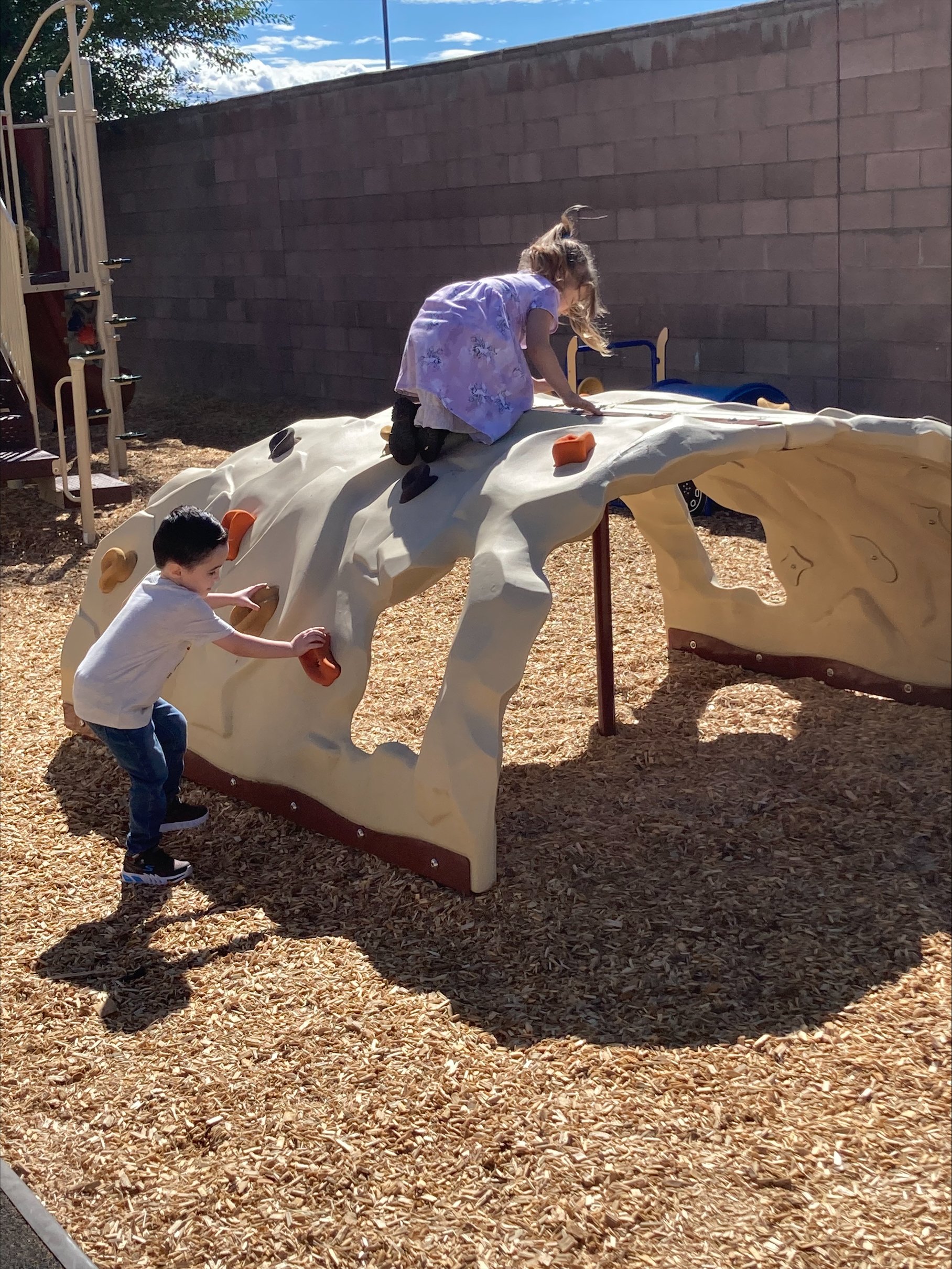 Students playing on new playground equipment
