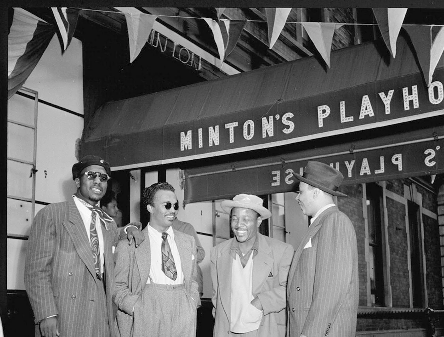 Pictured (left to right): Thelonious Monk, Howard McGhee, Roy Eldridge, and Teddy Hill at the door of Minton’s Playhouse in 1947 (Photo by William P. Gottlieb).