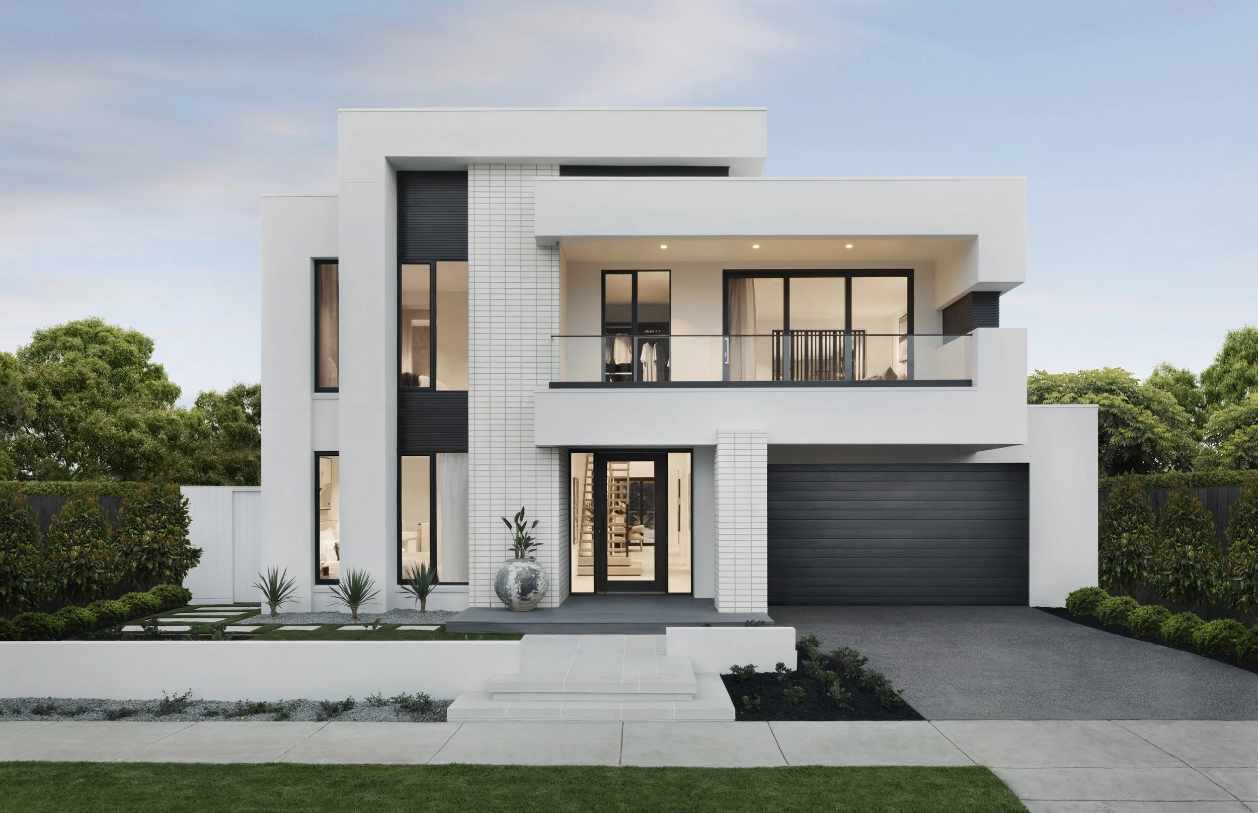 Modern two-story white house with black accents, ledge balcony, front garden with plants, and a driveway with a dark garage door.