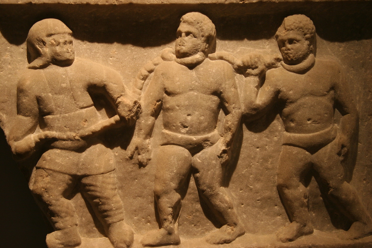 Fig. 2.1: Roman soldier with two slaves in neck collars. (Click the image to see the Ashmolean Museum where this relief is housed)