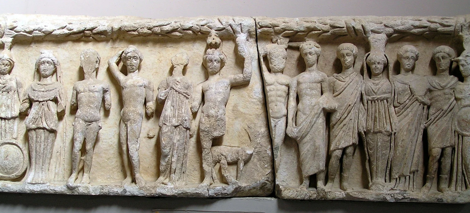 Fig. 3.6: Relief of deities, Ephesus Museum, 4th century CE. The figures have been identified from left to right as (1) Dae Roma, (2) Selene, (3) a god, (4) Apollo. (5) Artemis, (6) Androclos and his dog, (7) Heracles, (8) Dionysus, (9) Hermes or Em…