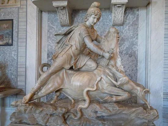 Fig. 3.18: One of the most common representations of the Mithraic mysteries that has survived is the slaying of the sacred bull by the god Mithras who comes down from heaven to perform a sacrificial act. The bull’s blood appears to be desired by the…