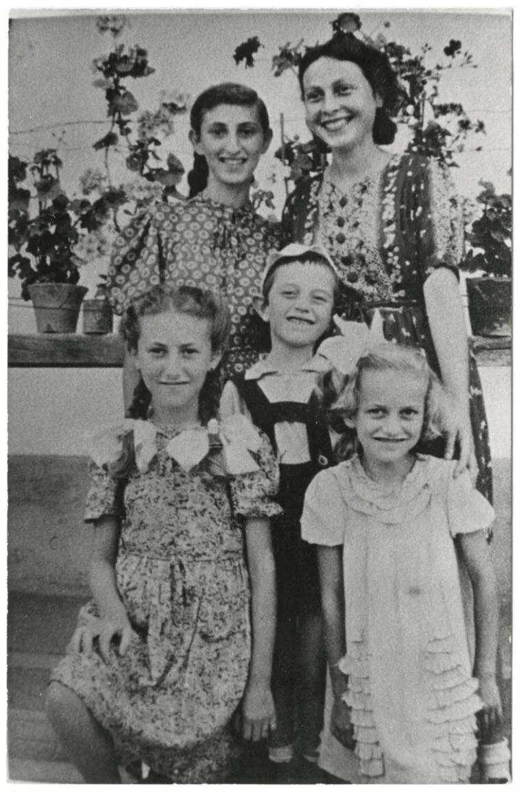 Irene (pictured bottom left) with her siblings and mother