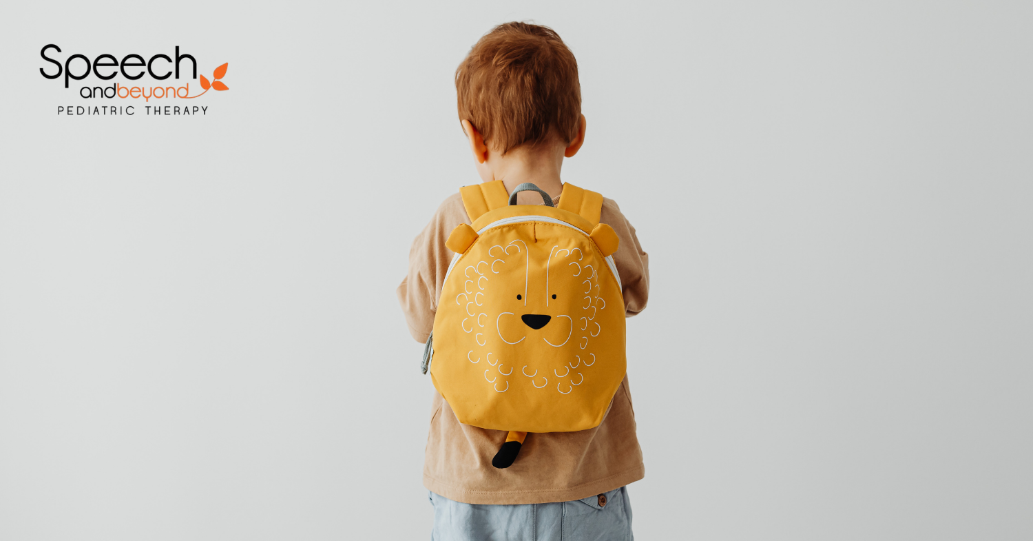 a small child with a yellow lion backpack