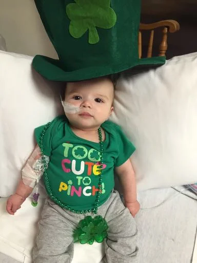 Whit with IV and shamrock outfit | Trilateral Retinoblastoma Story