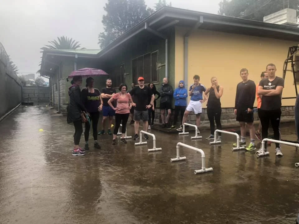 Getting HIIT instructions while getting soaked. (Photo credit to Melissa Varma)
