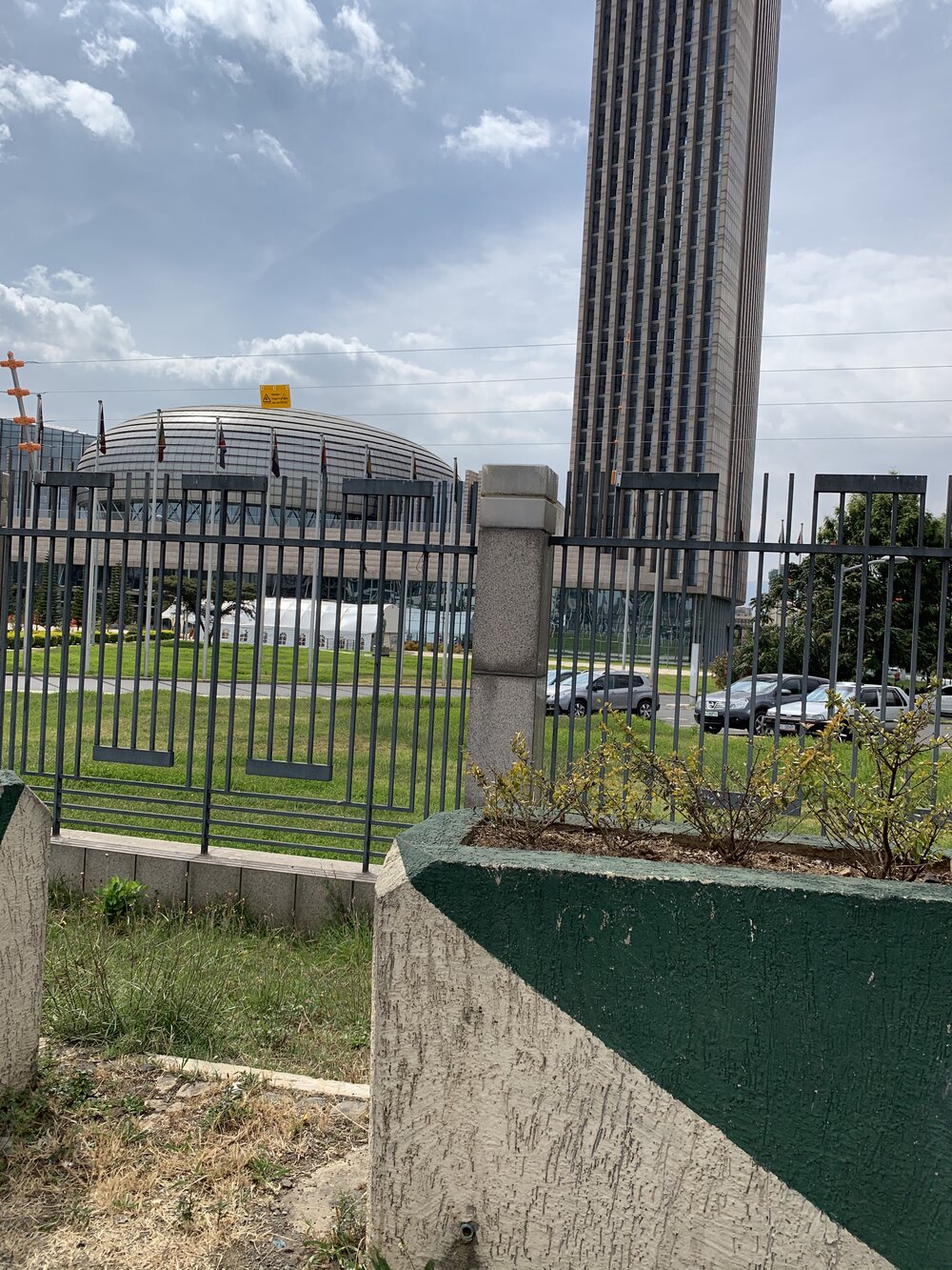 The AU central assembly building, as viewed through the fencing.