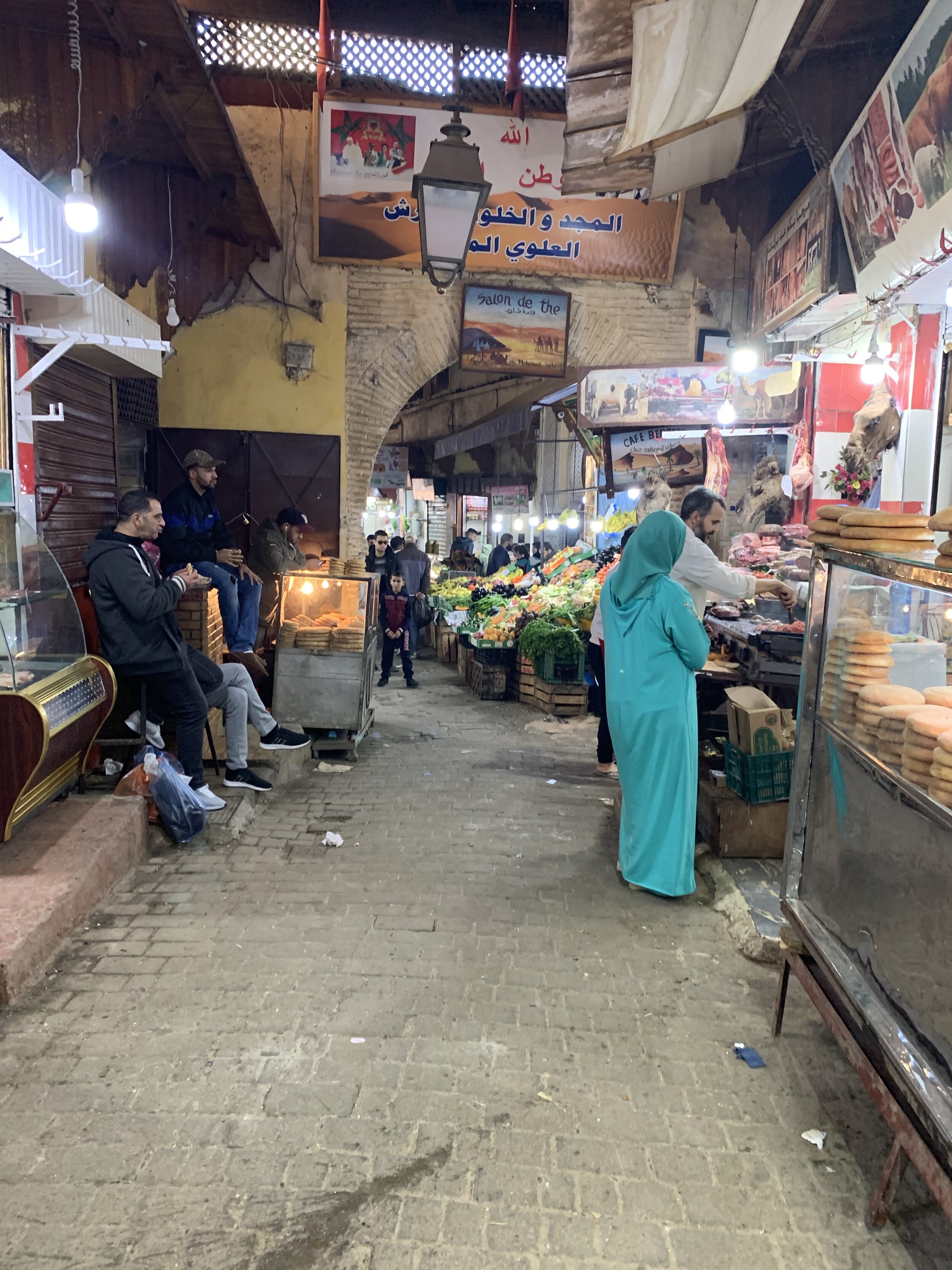 A sneaky shot of a butcher where you can see the camel heads near the lights if you look closely.