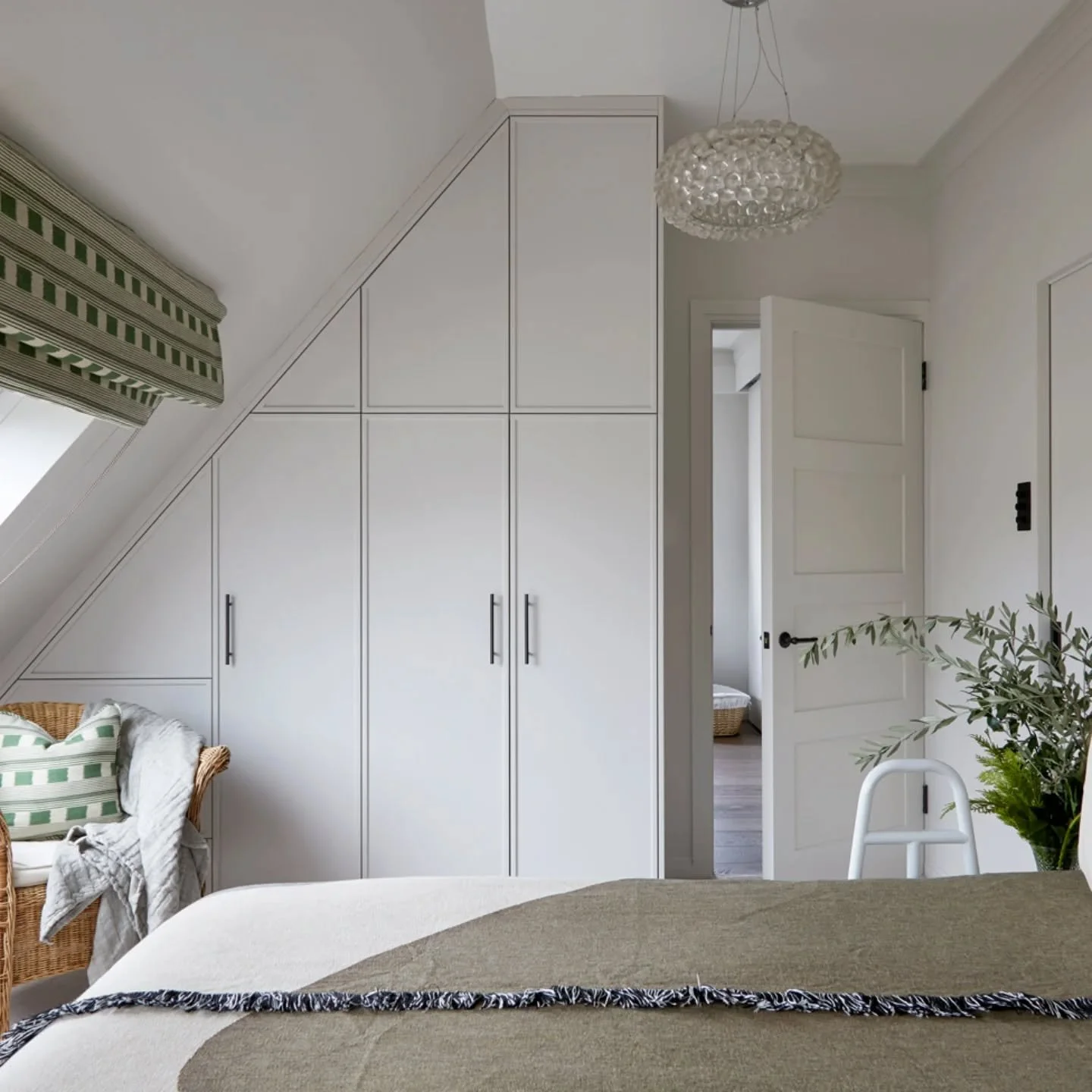 Bedroom. Tucked neatly under the sloped roof is a fitted wardrobe that feels like part of the wall. Beautifully built by @jongrant.london. 

@annastathakiphoto @thecurtaintailor 

#bedroom #masterbedroomdesign #renovation #penthouse #islington #calmm