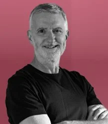 Paul Rutherford, Commercial Director of EMEA at Zefyr Consulting, smiling at camera with a pink overlay background.