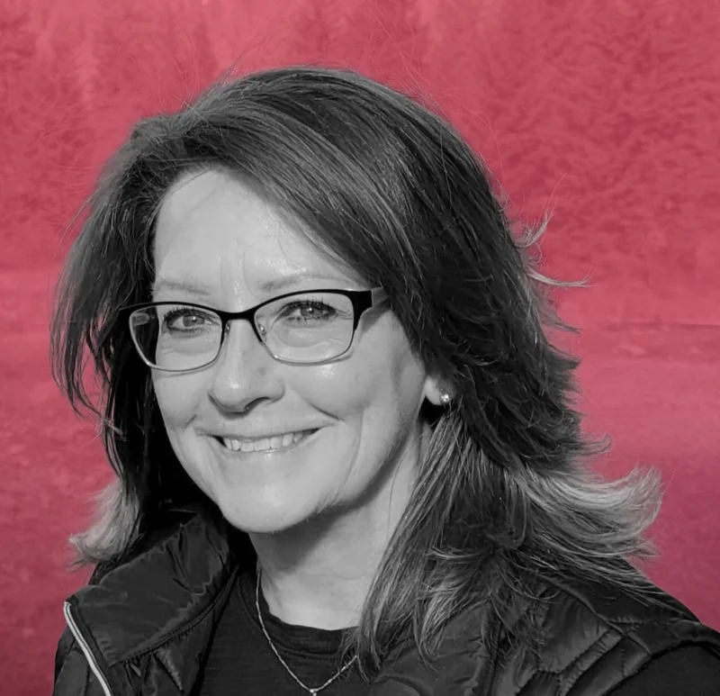 Krista Schreiber, Senior Consultant of Apparel Design & Sourcing at Zefyr Consulting, smiling at camera with a pink overlay background.