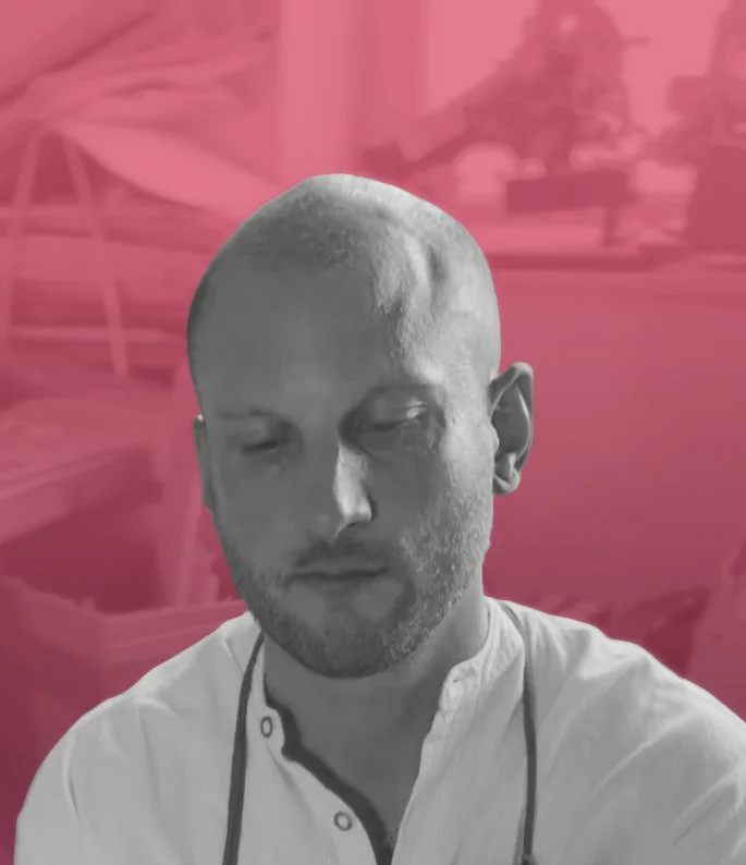 Daniel Doerfler, Senior Consultant of Footwear Development at Zefyr Consulting, smiling at camera with a pink overlay background.