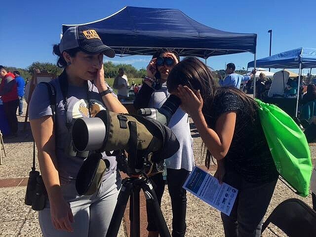 Looking through the scope at the Festival del Rio Anacostia