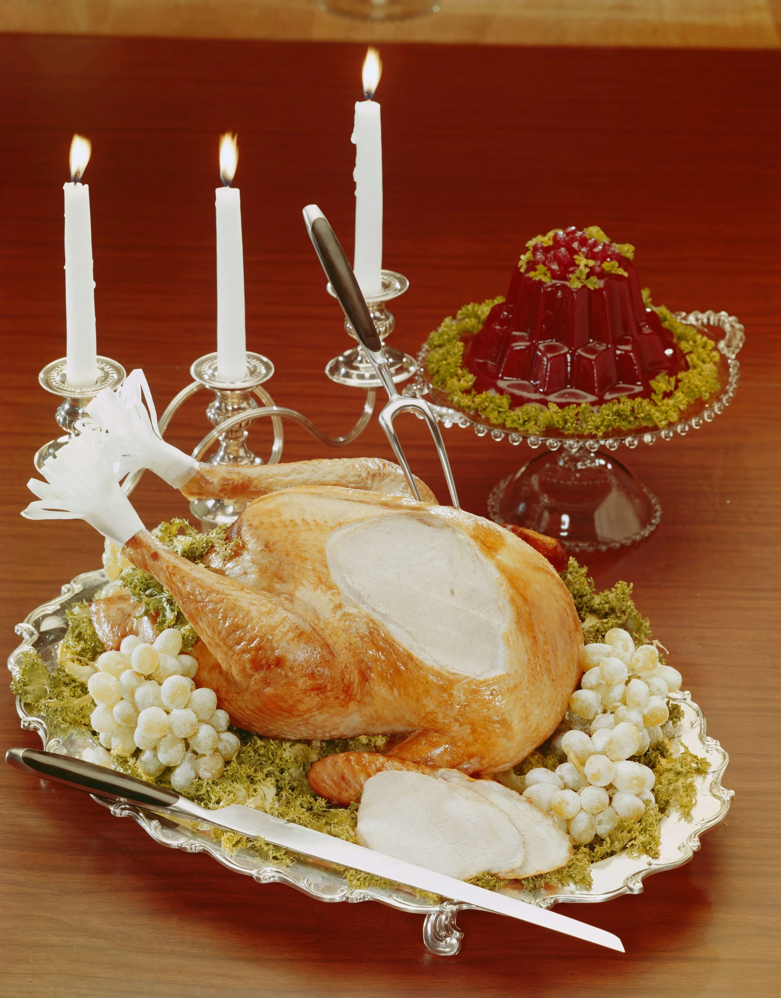 Vintage photo of a turkey and jello on a thanksgiving table.