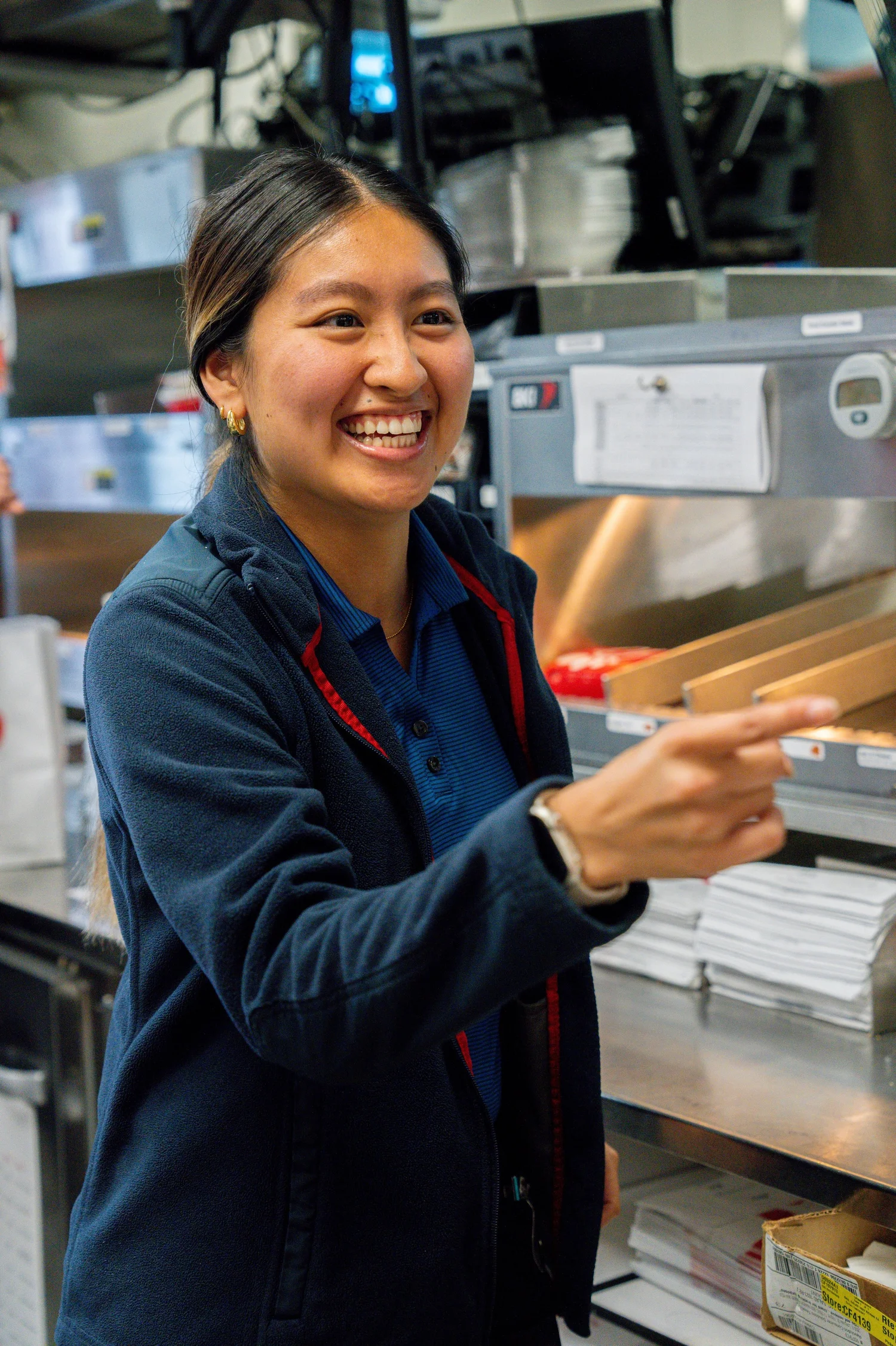 Chick-fil-A Boca Raton team members laughing together behind the counter