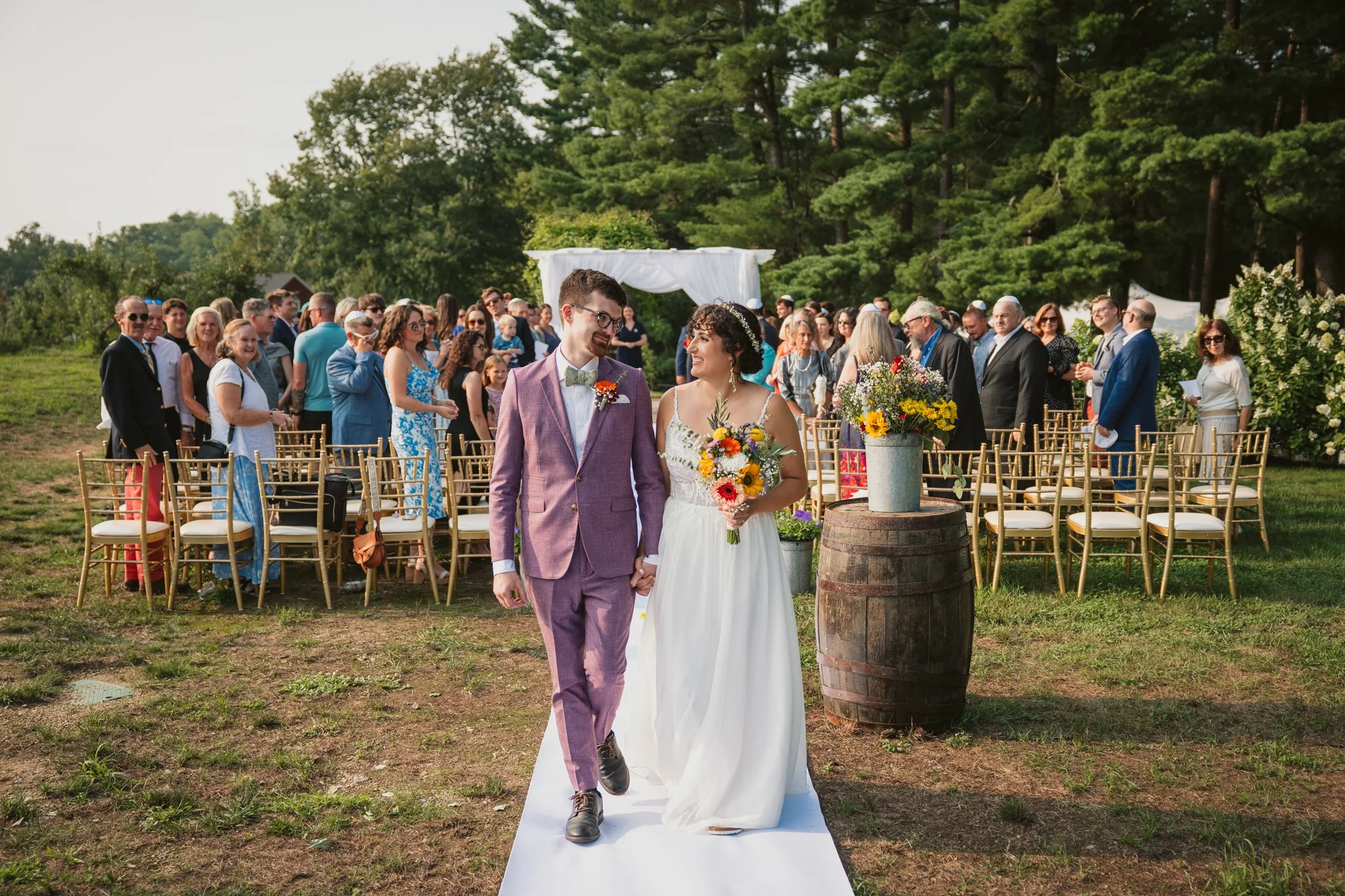 wedding ceremony recessional bride and groom smile at each other