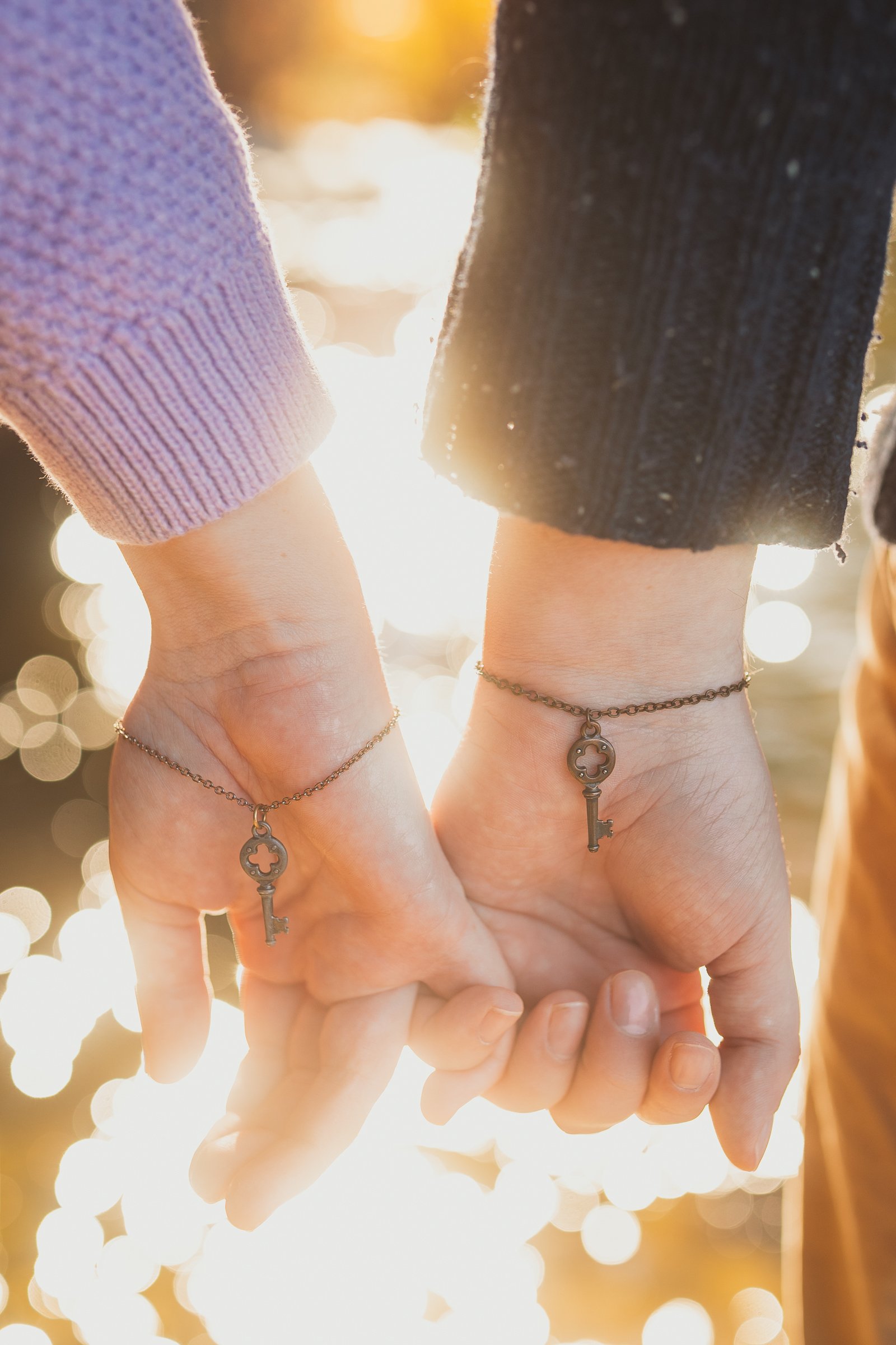 romantic-engagement-detail-holding-hands-golden-light.jpg