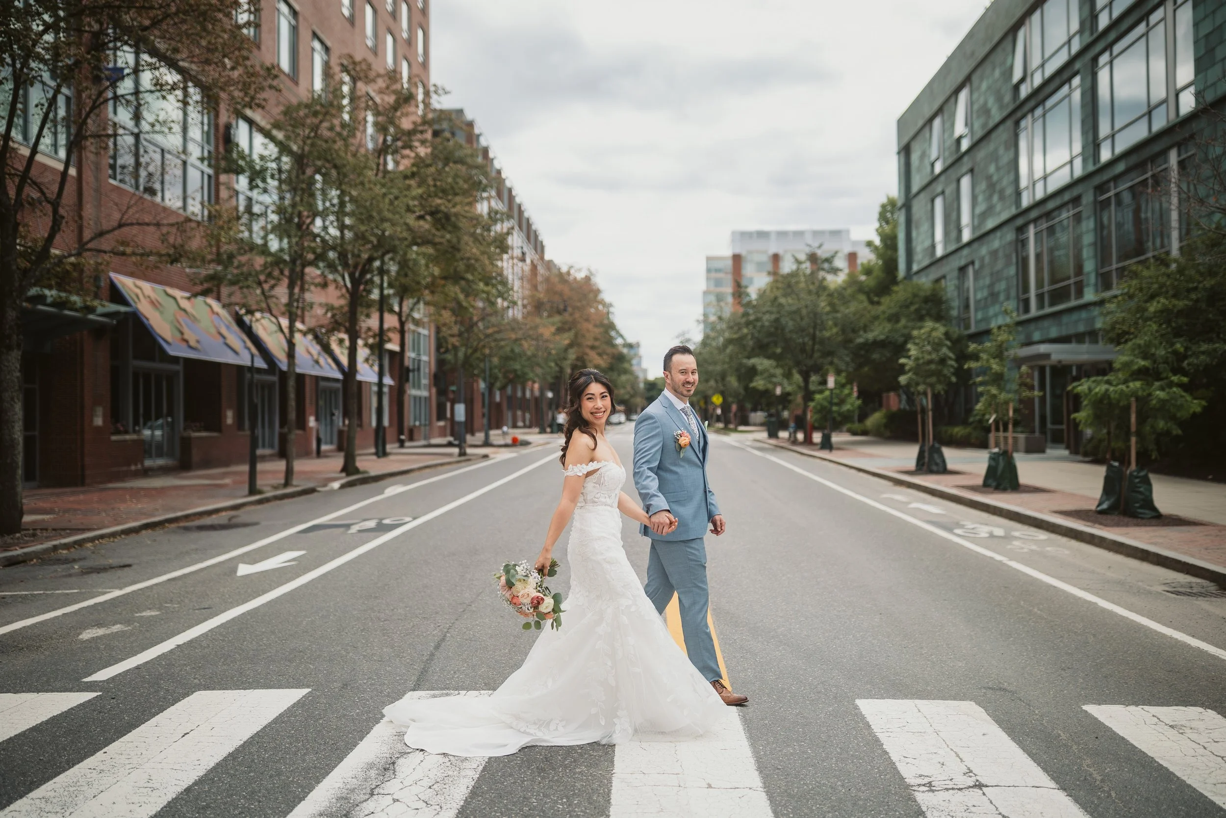bride and groom walking across street of cambridge pagu