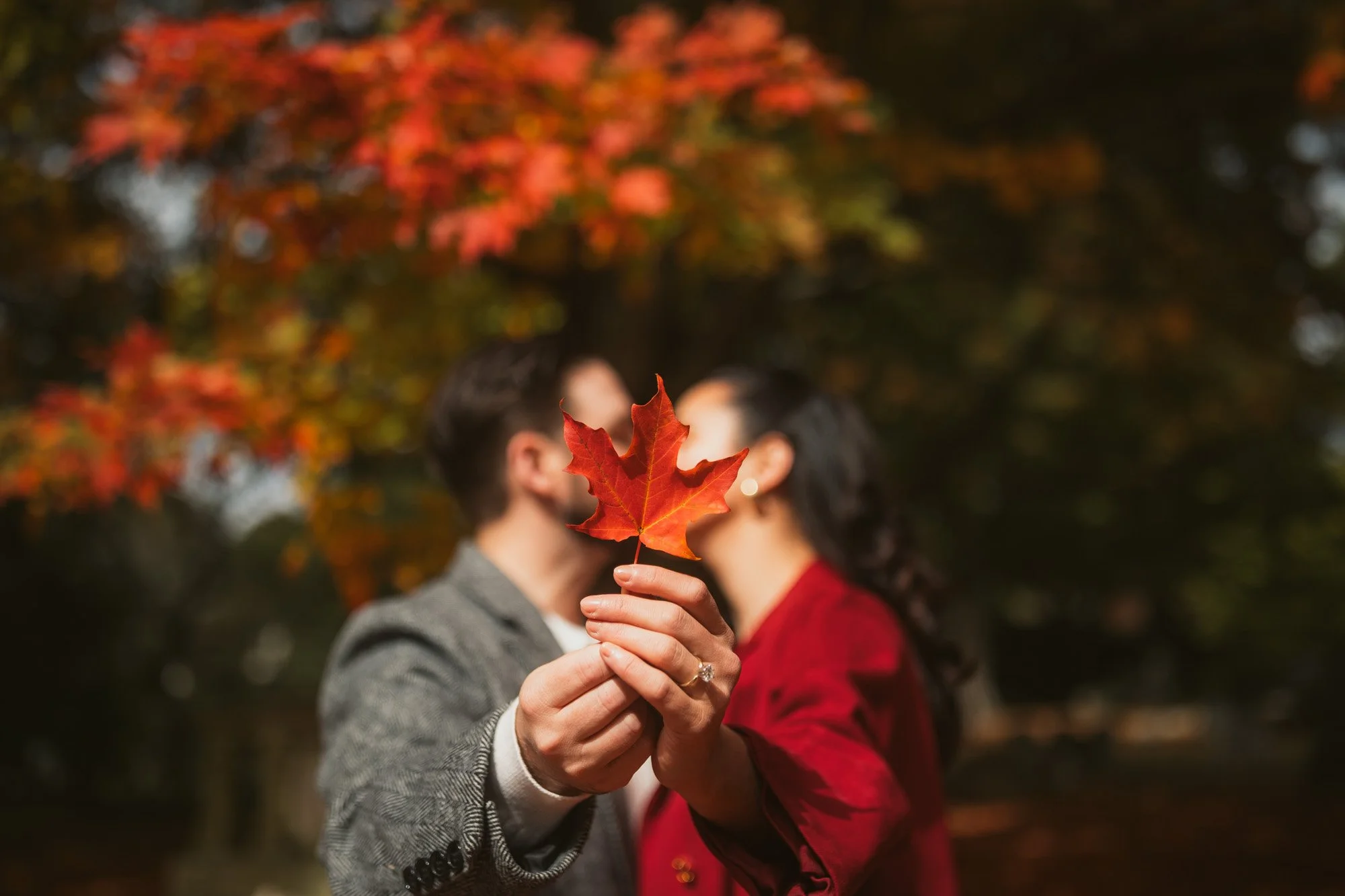 fall-engagement-photo-with-maple-leaf.jpg