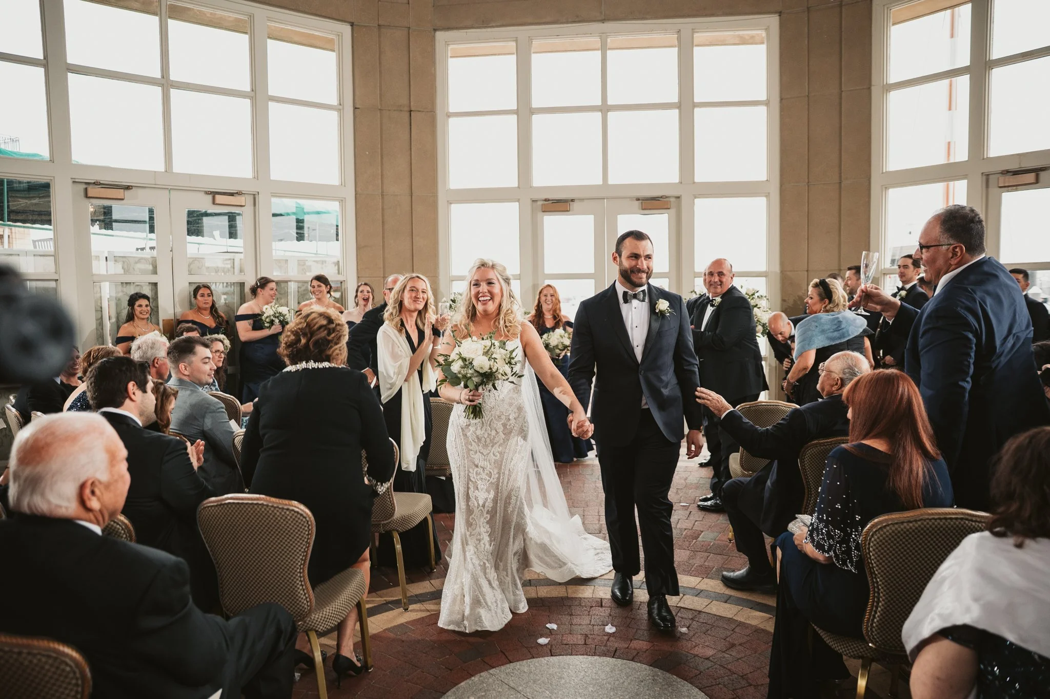 Bride and groom walking down the aisle at Foster Pavilion Boston Harbor Hotel